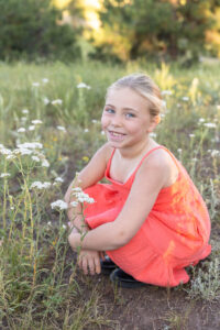 Littleton family photographer Mt. Falcon park Colorado sunset golden hour sisters photography mountain views mother father daughters wildflowers 