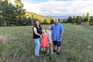 Littleton family photographer Mt. Falcon park Colorado sunset golden hour sisters photography mountain views mother father daughters wildflowers 