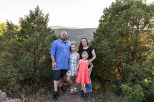 Littleton family photographer Mt. Falcon park Colorado sunset golden hour sisters photography mountain views mother father daughters wildflowers 