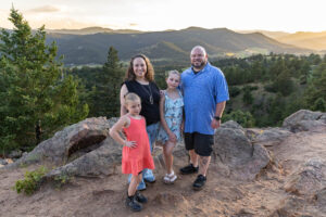 Littleton family photographer Mt. Falcon park Colorado sunset golden hour sisters photography mountain views mother father daughters wildflowers 