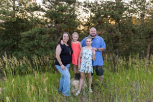 Littleton family photographer Mt. Falcon park Colorado sunset golden hour sisters photography mountain views mother father daughters wildflowers 