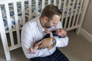Littleton family and newborn baby photographer Colorado in home lifestyle photography boy parents son brothers father daddy