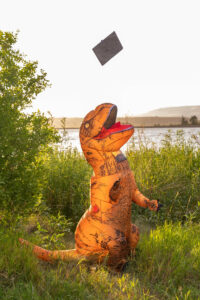 Littleton high school senior photographer Harriman Lake Lakewood Colorado photography teenager foothills lake sunset cap and gown dinosaur