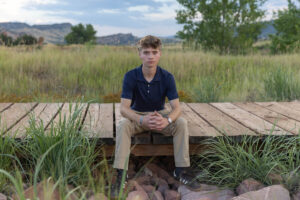 Littleton high school senior photographer South Valley Colorado family photo session portrait Navy siblings red rocks dogs photography sunset cross country track