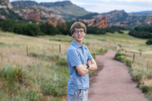 Littleton high school senior photographer South Valley Colorado family photo session portrait Navy siblings red rocks dogs photography sunset cross country track