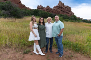 Littleton high school senior photographer Colorado Dakota Ridge class of 2026 nursing student photography South Valley red rocks sunset Writer's Vista park flowers family siblings mother father brother sister daughter son
