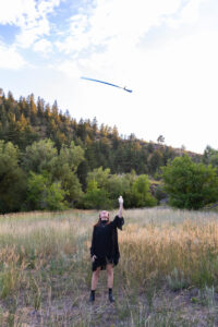 Littleton high school senior photographer teenager Downtown Morrison urban Lair O' the Bear Park nature water river bridge saber sword flag team color guard photography sunset Colorado foothills