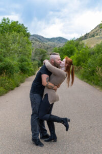 Littleton engagement photographer wedding marriage engaged couple in love future bride and groom Morrison park river water red rocks Mt. Falcon photography Colorado Wisconsin ring summer