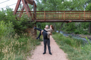 Littleton engagement photographer wedding marriage engaged couple in love future bride and groom Morrison park river water red rocks Mt. Falcon photography Colorado Wisconsin ring summer