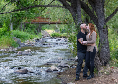 Littleton engagement photographer wedding marriage engaged couple in love future bride and groom Morrison park river water red rocks Mt. Falcon photography Colorado Wisconsin ring summer