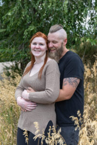 Littleton engagement photographer wedding marriage engaged couple in love future bride and groom Morrison park river water red rocks Mt. Falcon photography Colorado Wisconsin ring summer