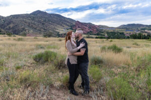 Littleton engagement photographer wedding marriage engaged couple in love future bride and groom Morrison park river water red rocks Mt. Falcon photography Colorado Wisconsin ring summer