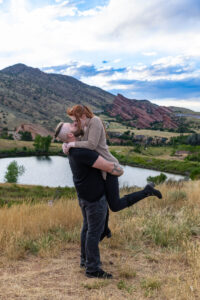 Littleton engagement photographer wedding marriage engaged couple in love future bride and groom Morrison park river water red rocks Mt. Falcon photography Colorado Wisconsin ring summer
