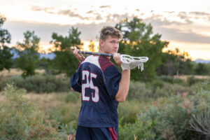Littleton high school senior photographer Carson Nature Center Colorado lacrosse player Dakota Ridge teenager boy teen sunset bridge friend