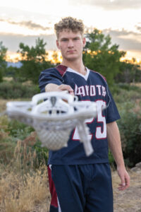 Littleton high school senior photographer Carson Nature Center Colorado lacrosse player Dakota Ridge teenager boy teen sunset bridge friend