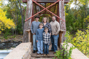 Littleton family photographer mini sessions Morrison Park fall photography Colorado dogs puppies couples mother father kids children siblings bridge river color brother sister baby
