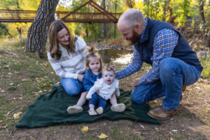 Littleton family photographer mini sessions Morrison Park fall photography Colorado dogs puppies couples mother father kids children siblings bridge river color brother sister baby