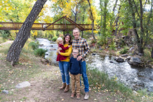 Littleton family photographer mini sessions Morrison Park fall photography Colorado dogs puppies couples mother father kids children siblings bridge river color brother sister baby