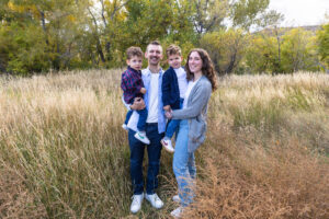 Littleton family photographer boys siblings brothers mother father fall Colorado Hildebrand Ranch photography foothills field Ken Caryl