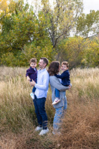 Littleton family photographer boys siblings brothers mother father fall Colorado Hildebrand Ranch photography foothills field Ken Caryl
