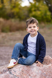 Littleton family photographer boys siblings brothers mother father fall Colorado Hildebrand Ranch photography foothills field Ken Caryl