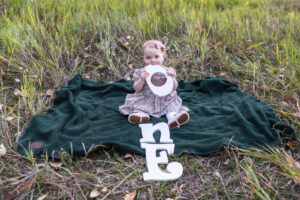 Littleton family photographer Fly'N B park Highlands Ranch Colorado one year old baby mother father child daughter little girl photography fall cake smash