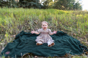 Littleton family photographer Fly'N B park Highlands Ranch Colorado one year old baby mother father child daughter little girl photography fall cake smash
