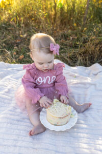 Littleton family photographer Fly'N B park Highlands Ranch Colorado one year old baby mother father child daughter little girl photography fall cake smash