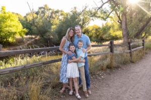 Littleton family photographer Stone House in Lakewood Colorado kids mother father photography brother sister fall sunset golden hour leaves wooden fence