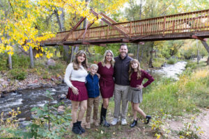 Littleton family photographer mini sessions Morrison Park fall photography Colorado dogs puppies couples mother father kids children siblings bridge river color brother sister baby