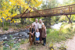 Littleton family photographer mini sessions Morrison Park fall photography Colorado dogs puppies couples mother father kids children siblings bridge river color brother sister baby