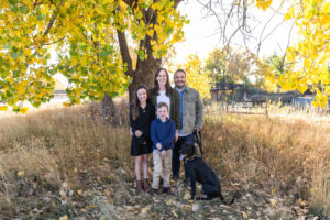 Littleton family photographer Carson Nature Center Colorado fall color bridge brother sister mother father siblings daughter son photography foothills dog fence log