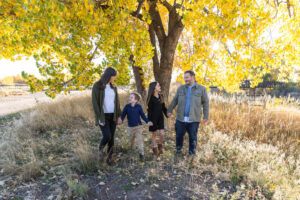 Littleton family photographer Carson Nature Center Colorado fall color bridge brother sister mother father siblings daughter son photography foothills dog fence log