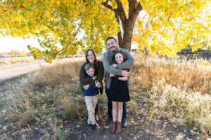 Littleton family photographer Carson Nature Center Colorado fall color bridge brother sister mother father siblings daughter son photography foothills dog fence log