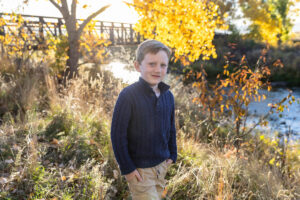 Littleton family photographer Carson Nature Center Colorado fall color bridge brother sister mother father siblings daughter son photography foothills dog fence log