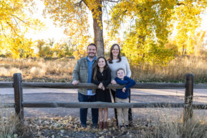 Littleton family photographer Carson Nature Center Colorado fall color bridge brother sister mother father siblings daughter son photography foothills dog fence log