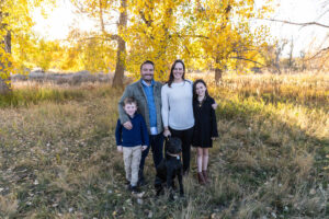 Littleton family photographer Carson Nature Center Colorado fall color bridge brother sister mother father siblings daughter son photography foothills dog fence log