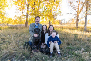 Littleton family photographer Carson Nature Center Colorado fall color bridge brother sister mother father siblings daughter son photography foothills dog fence log