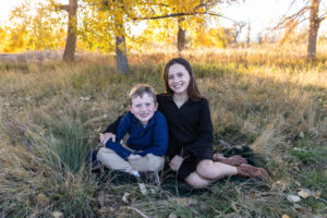 Littleton family photographer Carson Nature Center Colorado fall color bridge brother sister mother father siblings daughter son photography foothills dog fence log