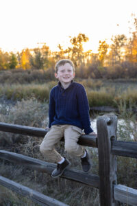 Littleton family photographer Carson Nature Center Colorado fall color bridge brother sister mother father siblings daughter son photography foothills dog fence log