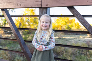 Littleton family photographer extended fall photo session Colorado grandmother granddaughter sisters husbands South Platte river area Carson Nature Center photography mother father child yellow leaves bridge