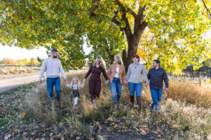 Littleton family photographer extended fall photo session Colorado grandmother granddaughter sisters husbands South Platte river area Carson Nature Center photography mother father child yellow leaves walking