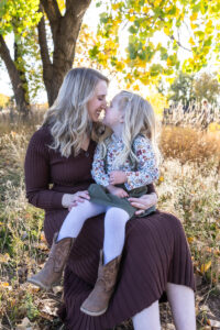 Littleton family photographer extended fall photo session Colorado grandmother granddaughter sisters husbands South Platte river area Carson Nature Center photography mother father child yellow leaves nose kisses