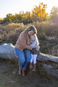Littleton family photographer extended fall photo session Colorado grandmother granddaughter sisters husbands South Platte river area Carson Nature Center photography mother father child yellow leaves hugs snuggles