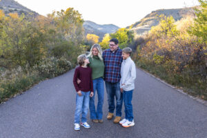 Littleton family photographer Morrison Park Colorado fall leaves color foothills photography brothers mother father sons bridge river