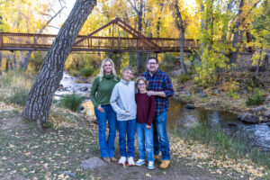 Littleton family photographer Morrison Park Colorado fall leaves color foothills photography brothers mother father sons bridge river