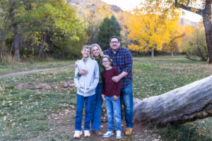 Littleton family photographer Morrison Park Colorado fall leaves color foothills photography brothers mother father sons bridge river