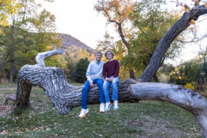 Littleton family photographer Morrison Park Colorado fall leaves color foothills photography brothers mother father sons bridge river