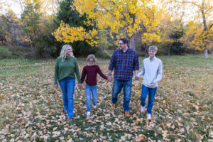 Littleton family photographer Morrison Park Colorado fall leaves color foothills photography brothers mother father sons bridge river