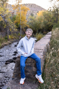 Littleton family photographer Morrison Park Colorado fall leaves color foothills photography brothers mother father sons bridge river
